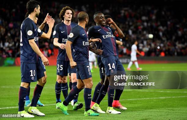 Paris Saint-Germain's French midfielder Blaise Matuidi celebrates with his teammates after scoring a goal during the French L1 football match between...