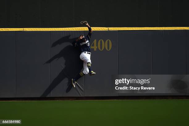 Keon Broxton of the Milwaukee Brewers catches a fly ball against the wall during the ninth inning of a game against the Chicago Cubs at Miller Park...
