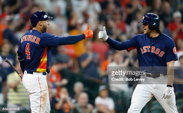 Jake Marisnick of the Houston Astros, right, celebrates with George Springer after hitting a home run in the ninth inning against the Kansas City...