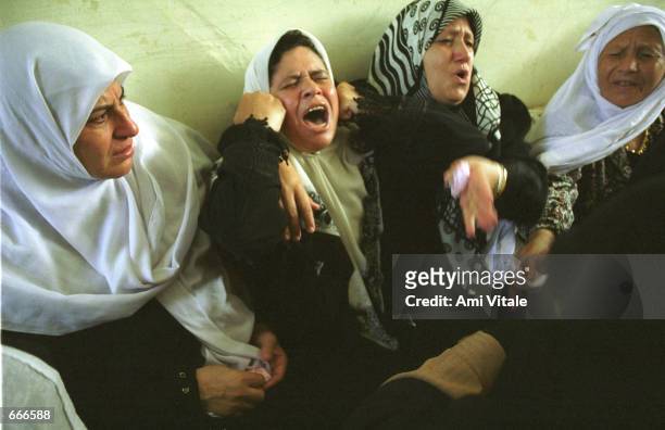 The family of 18 year-old Palestinian Yusuf Khalifa mourns the teenager's death October 9, 2000 in Gaza after he was killed during clashes with...