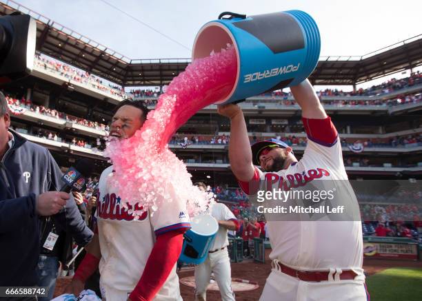 Cameron Rupp of the Philadelphia Phillies pours Powerade on Cesar Hernandez of the Philadelphia Phillies after Hernandez hit a walk off single in the...
