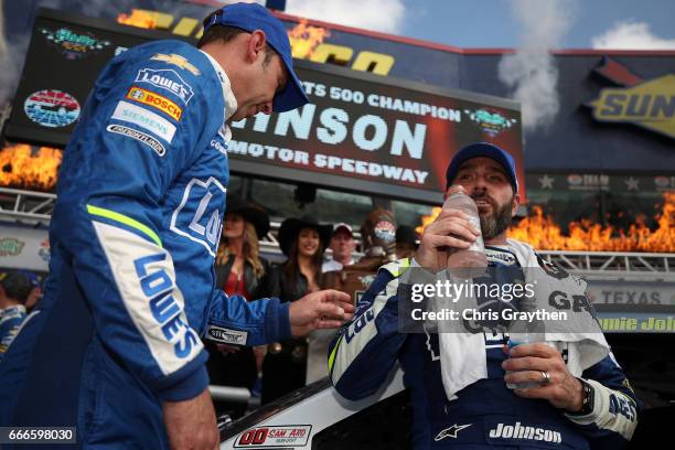Jimmie Johnson, driver of the Lowe's Chevrolet, and crew chief Chad Knaus talk after winning during the Monster Energy NASCAR Cup Series O'Reilly...