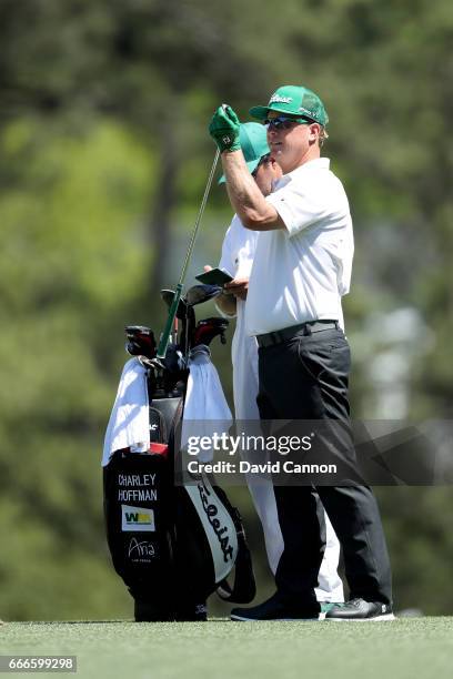 Charley Hoffman of the United States pulls a club from his bag on the first hole during the final round of the 2017 Masters Tournament at Augusta...