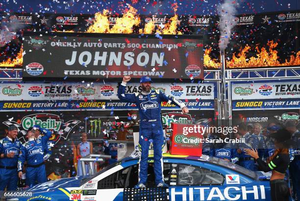 Jimmie Johnson, driver of the Lowe's Chevrolet, celebrates in Victory Lane after winning the Monster Energy NASCAR Cup Series O'Reilly Auto Parts 500...
