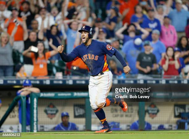 George Springer of the Houston Astros scores the winning run in the twelfth inning on an Evan Gattis walk by Matt Strahm of the Kansas City Royals at...