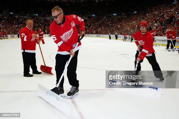 Former Detroit Red Wing Darren McCarty shovels the ice during a timeout at the last NHL game at Joe Louis Arena between the New Jersey Devils and...