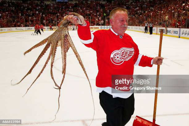 Building operations manager for Olympia Entertainment Al Sobotka collects an octopus during a timeout at the last NHL game at Joe Louis Arena between...