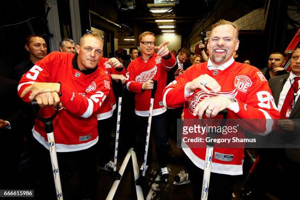 From L-R Former Detroit Red Wings Darren McCarty, Larry Murphy and Tomas Holmstrom prepare to shovel the ice during a timeout at the last NHL game at...