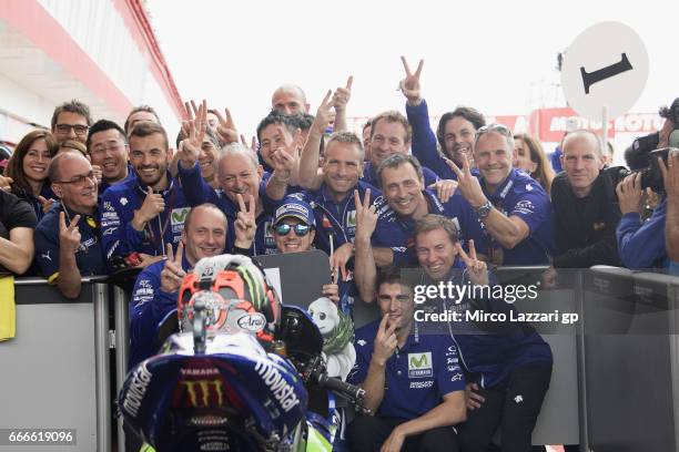 Maverick Vinales of Spain and Movistar Yamaha MotoGP celebrates the victory with team under the podium at the end of the MotoGP race during the...