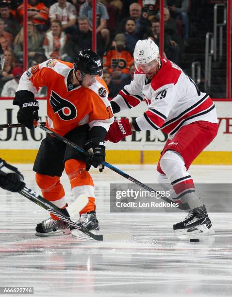 Brayden Schenn of the Philadelphia Flyers battles for the loose puck with Bryan Bickell of the Carolina Hurricanes on April 9, 2017 at the Wells...