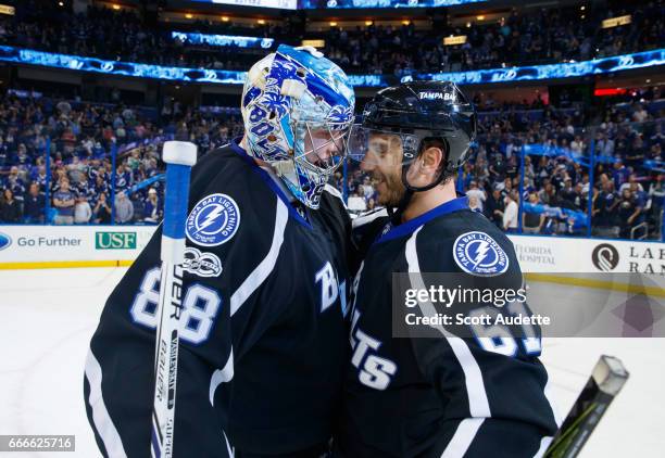 Goalie Andrei Vasilevskiy and Gabriel Dumont of the Tampa Bay Lightning celebrate the win against the Buffalo Sabres at Amalie Arena on April 9, 2017...
