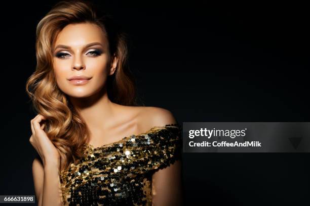 beautiful woman wearing golden dress - model gold dress stock pictures, royalty-free photos & images