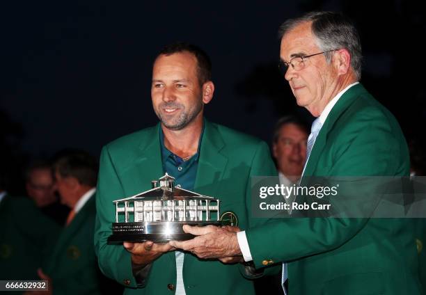 Chairman of Augusta National Golf Club, William Porter Payne , hands the Masters Trophy to Sergio Garcia of Spain during the Green Jacket ceremony...