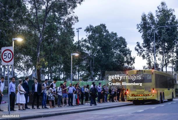 Commuters wait in line as a Hillsbus Co. Bus stops at the Riley T-Way bus station in the suburb of Kellyville in Sydney, Australia, on Thursday,...