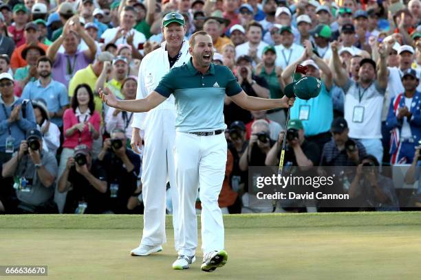 Sergio Garcia of Spain celebrates with caddie Glen Murray after defeating Justin Rose of England on the first playoff hole during the final round of...