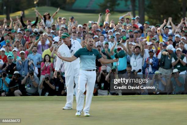 Sergio Garcia of Spain celebrates with caddie Glen Murray after defeating Justin Rose of England on the first playoff hole during the final round of...