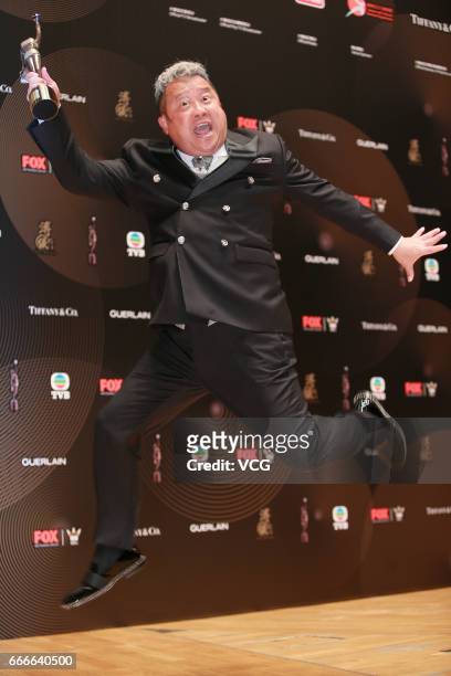 Actor Eric Tsang, winner of Best Supporting Actor award for film 'Mad World', celebrates at the backstage of the 36th Hong Kong Film Awards at Hong...