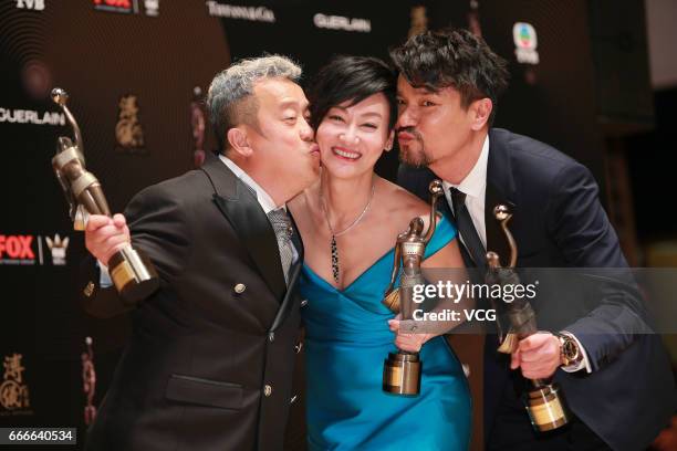 Best Supporting Actor award winner Eric Tsang, Best Actress award winner Kara Wai and Best Actor award winner Lam Ka Tung celebrate at the backstage...