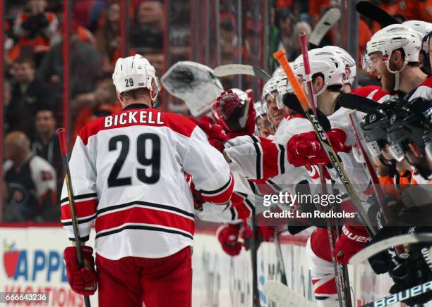 Bryan Bickell of the Carolina Hurricanes celebrates with his teammates on the bench after scoring a goal in the shootout against the Philadelphia...