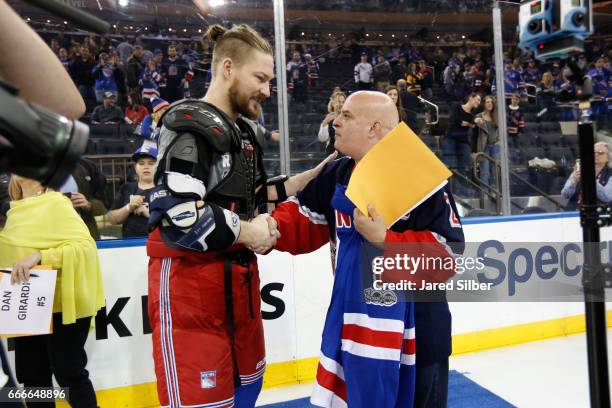 Kevin Klein of the New York Rangers greets a fan during the Blueshirts Off Our Back celebration following the final home game of the regular season...