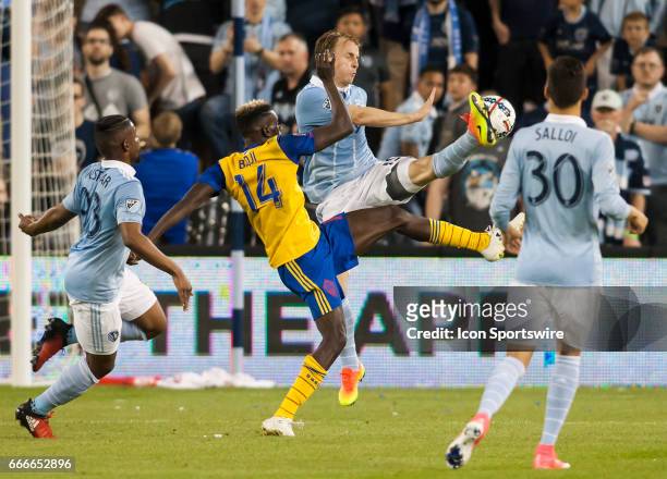 Defender Seth Sinovic and Forward Dominique Badji fight for possession of the ball during the MLS match between Sporting Kansas City and the Colorado...