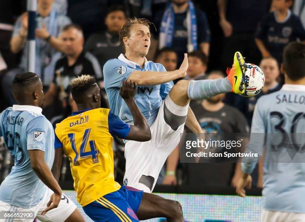 Defender Seth Sinovic and Forward Dominique Badji fight for possession of the ball during the MLS match between Sporting Kansas City and the Colorado...