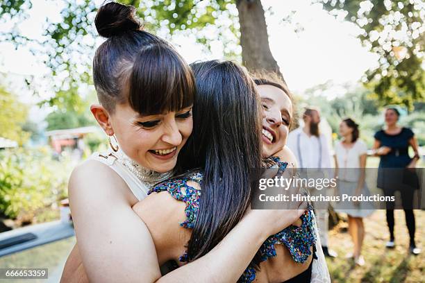 newlywed lesbian couple being congratulated - wedding congratulations photos et images de collection