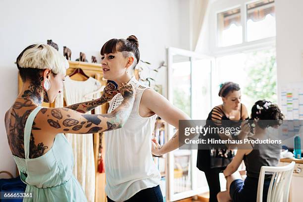 lesbian couple getting ready for their wedding - bride getting dressed stock pictures, royalty-free photos & images