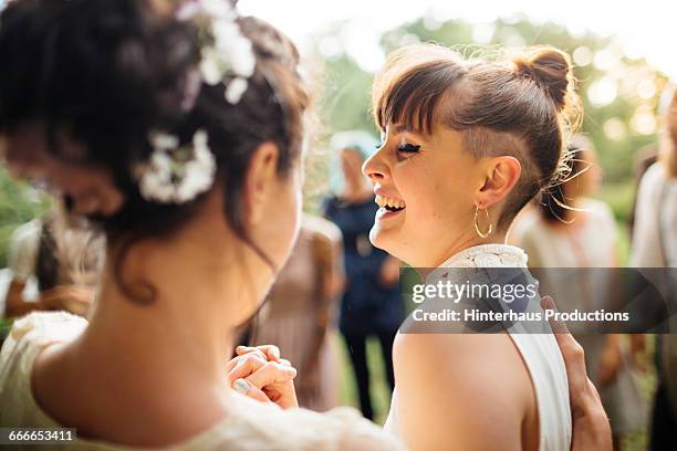 newlywed lesbian couple dancing - wedding couple laughing photos et images de collection