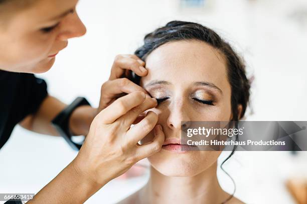 bride getting make-up applied - bridal makeup stock pictures, royalty-free photos & images