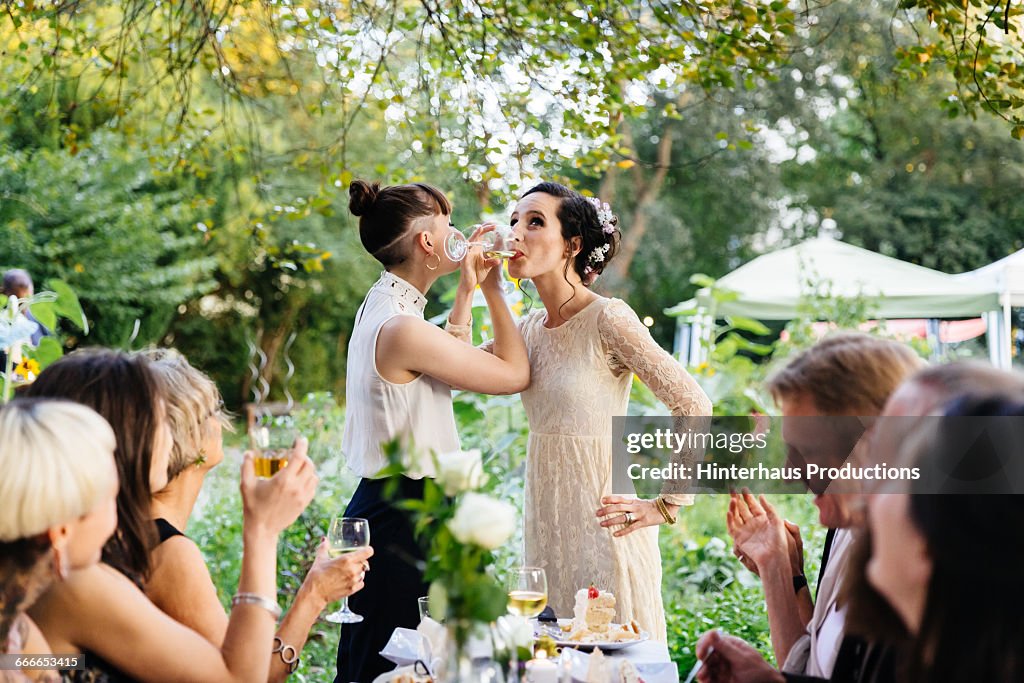 Newlywed lesbian couple drinking
