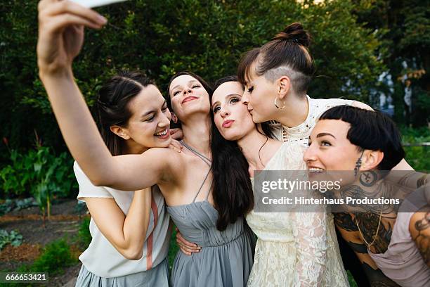 newlywed lesbian couple with friends doing selfie - wedding role stock pictures, royalty-free photos & images