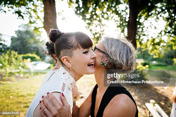 newlywed lesbian couple being congratulated - wedding congratulations photos et images de collection