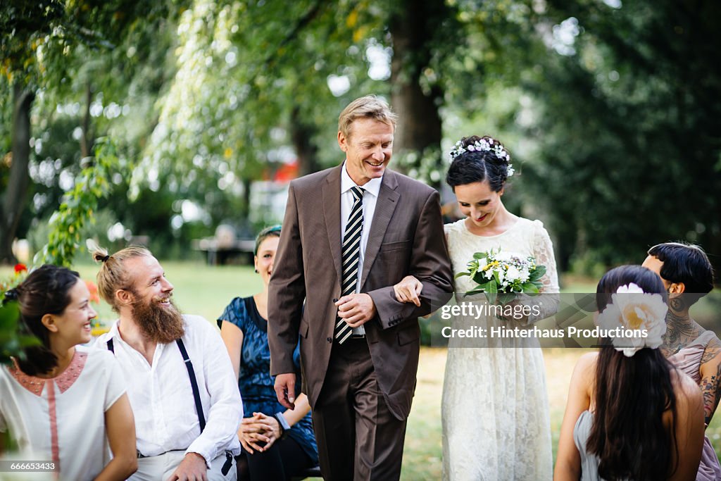 Father guiding his daughter to the altar