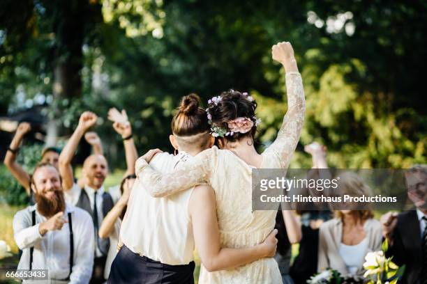 lesbian couple celebrating their marriage - matrimonio fotografías e imágenes de stock