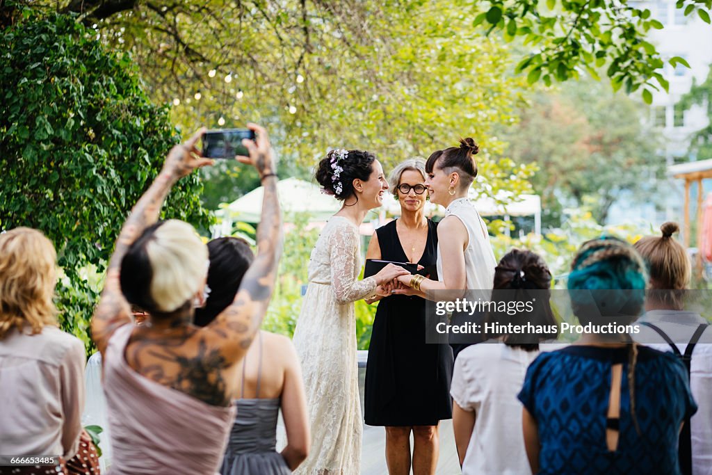 Lesbian couple standing at the alter