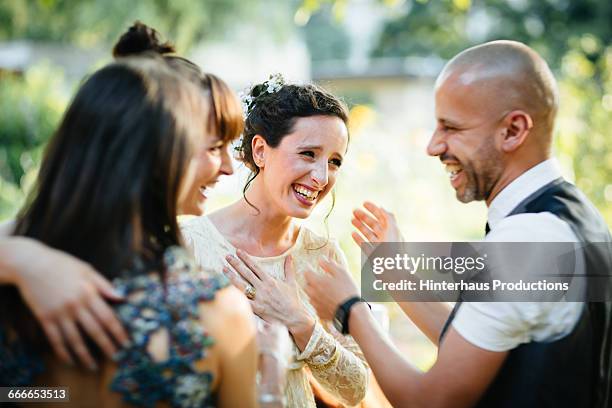 newlywed lesbian couple being congratulated - wedding guest stock-fotos und bilder