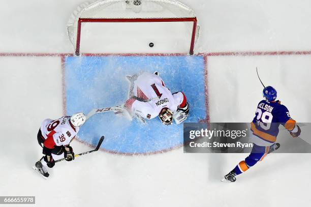 Brock Nelson of the New York Islanders scores a goal past Mike Condon of the Ottawa Senators during an NHL game at Barclays Center on April 9, 2017...