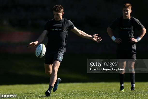 Beauden Barrett kicks while brother Jordie Barrett looks on during a Hurricanes Super Rugby training session at Rugby League Park on April 10, 2017...
