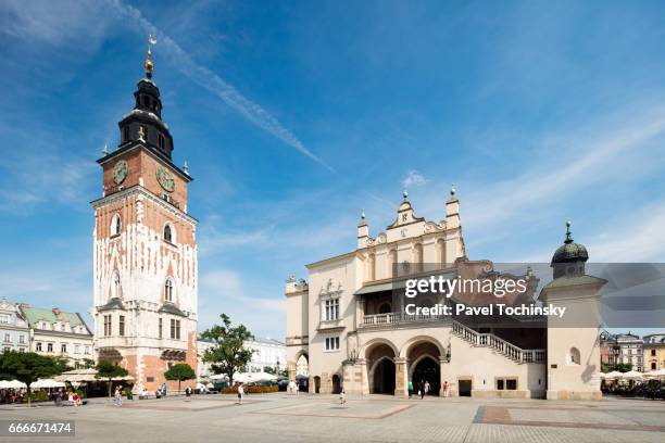 gothic town hall tower (left) on krakow's main square along with sukiennice (right) cloth hall, poland - rynek glowny square stock-fotos und bilder