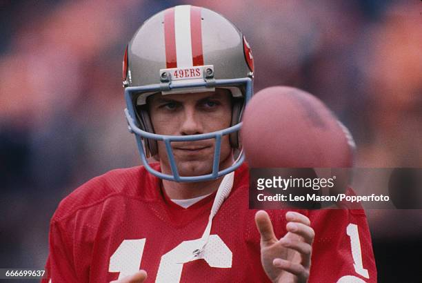 American football quarterback Joe Montana , pictured with the ball playing for the San Francisco 49ers during Super Bowl XIX at Stanford Stadium in...