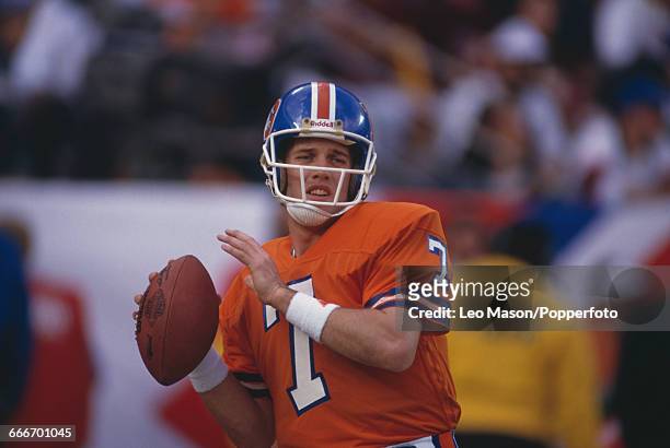 American football quarterback John Elway, pictured in action playing for the Denver Broncos against the Washington Redskins during Super Bowl XXII at...