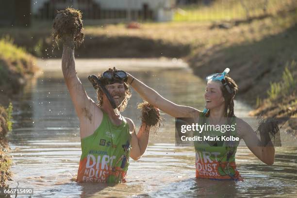 Neil Batt and Aimie Athorn cover each other in mud during a media opportunity at the bog snorkelling pit at the Dirt 'n' Dust Festival 2017 on April...