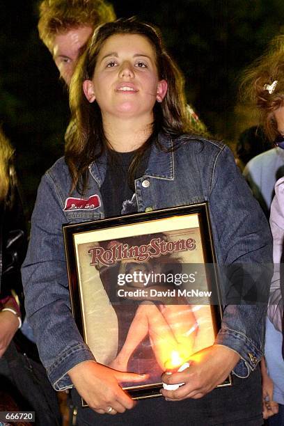 Katie Zeoli holds a copy of the famous Rolling Stone magazine cover featuring a nude John Lennon with his wife Yoko Ono, October 9, 2000 in...