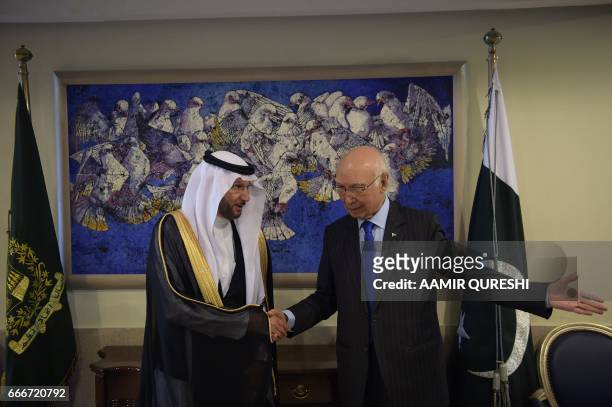 Pakistan's National Security Advisor Sartaj Aziz guides Organisation of Islamic Cooperation Secretary-General Yousef Bin Ahmad Al-Othaimeen at the...