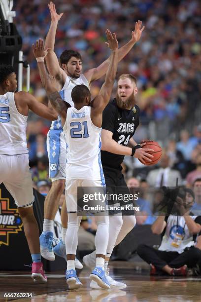Luke Maye and Seventh Woods of the North Carolina Tar Heels defend Przemek Karnowski of the Gonzaga Bulldogs during the 2017 NCAA Men's Final Four...