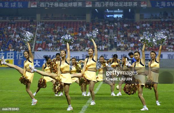 Cheerleaders perform during a match between the Shanghai Shenhua SVA and the Tianjin Kangshifu as China's soccer Division A League resumed play in...