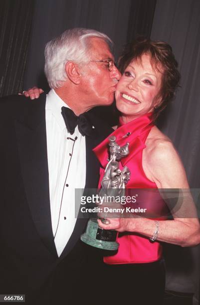 Actor Dick Van Dyke gives actress Mary Tyler Moore a kiss on the cheek at the "45th Thalians Annual Ball" honoring Mary Tyler Moore for her...