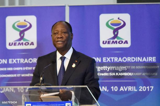 Ivory Coast's president Alassane Ouattara delivers a speech during the opening of the extraordinary session of the West African Economic and Monetary...