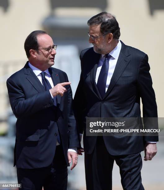 French President Francois Hollande and Spanish Prime Minister Maiano Rajoy chat as they walk on April 10, 2017 at the Palacio del Pardo, near the...